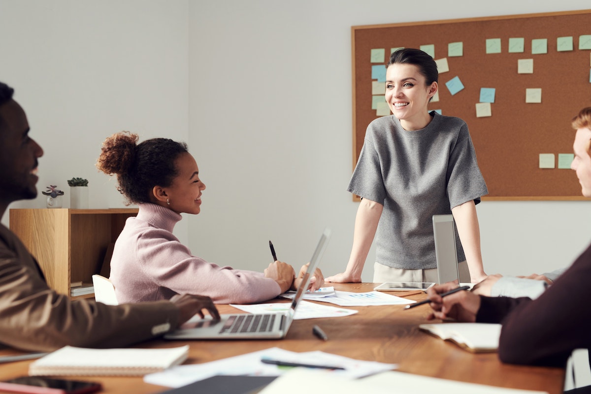 A Team of Four Meets to Discuss Marketing Plans in a Modern Office Salsify Brand Experiences