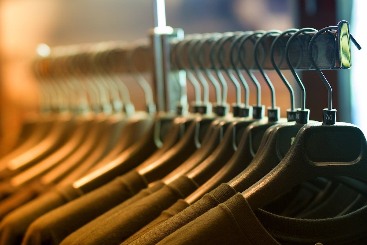 Green Shirts on Wooden Hangers Sit on a Clothing Rack Salsify Clothing Brands Manage Syndication